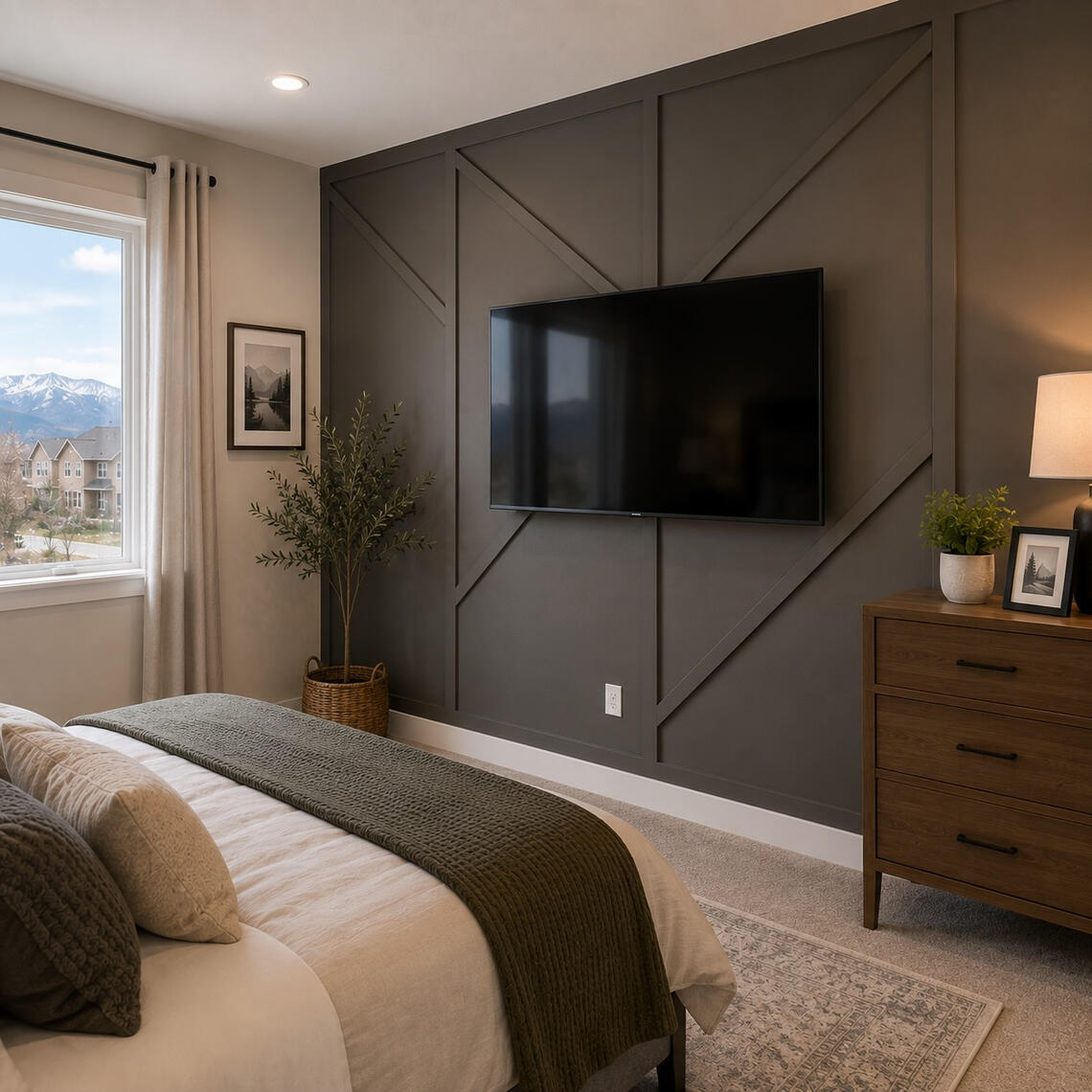 Dark gray geometric accent wall with mounted TV in modern bedroom Charlotte NC